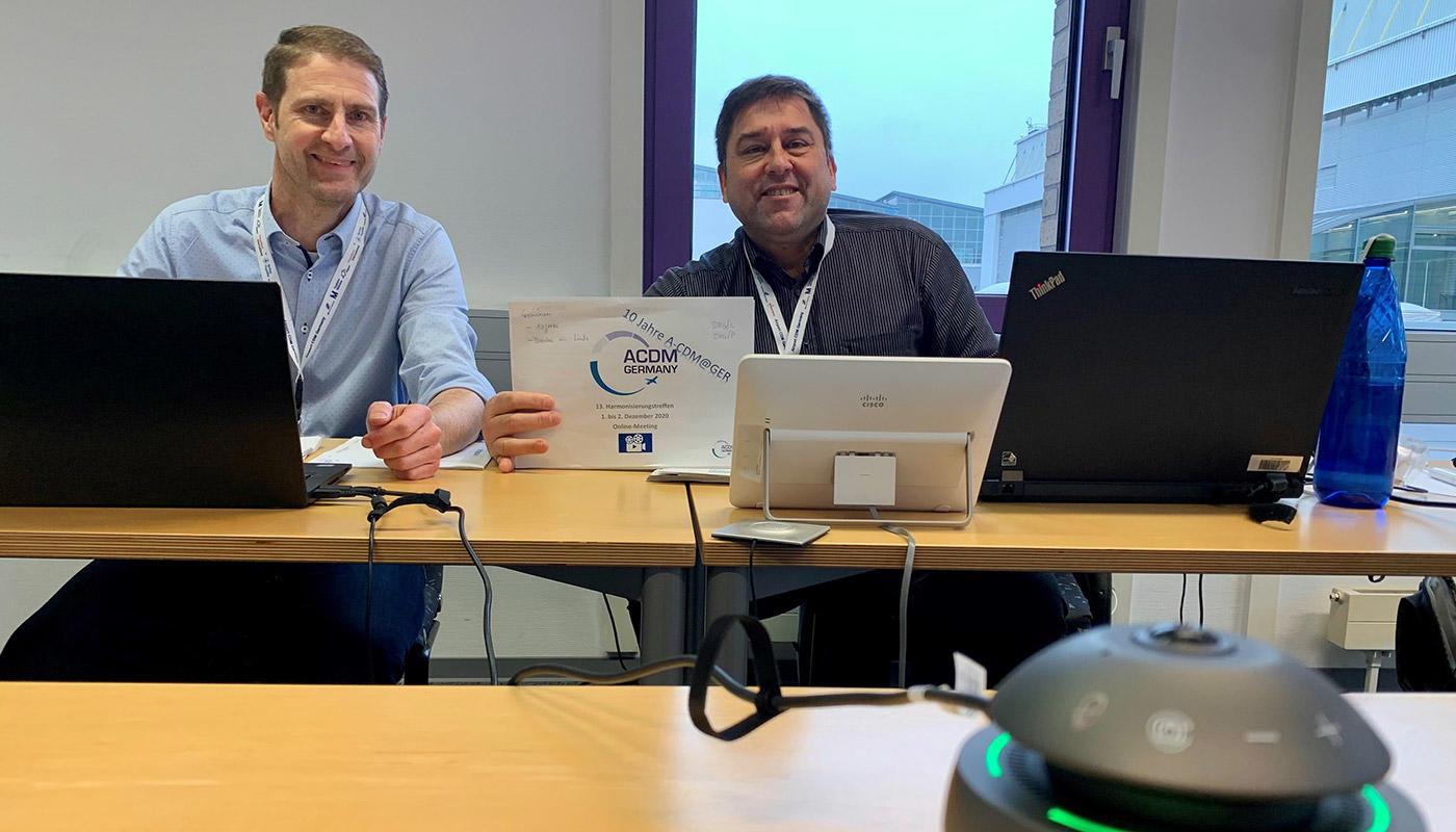 13th ACDM@GER Harmonisation Meeting The ACDM@GER chairmen Nico Ruwe (FSG, left) and Erik Sinz (DFS) next to another important team member: a 360-degree webcam