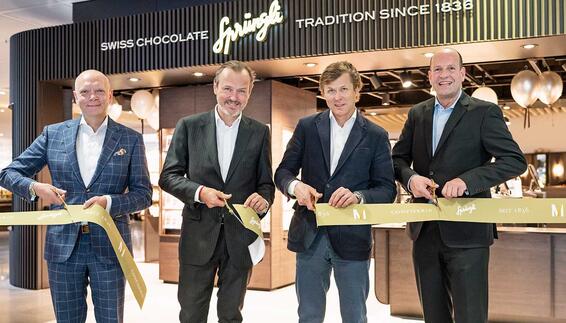 Forming up for ribbon cutting at the opening of the new store were (from left) Sven Zahn, Managing Director of Eurotrade Flughafen München GmbH, Milan Prenosil, Chairman of the Board of Sprüngli, Tomas Prenosil, Chief Executive Officer of Sprüngli, and Dr. Jan-Henrik Andersson, Chief Commercial Officer Flughafen München GmbH.