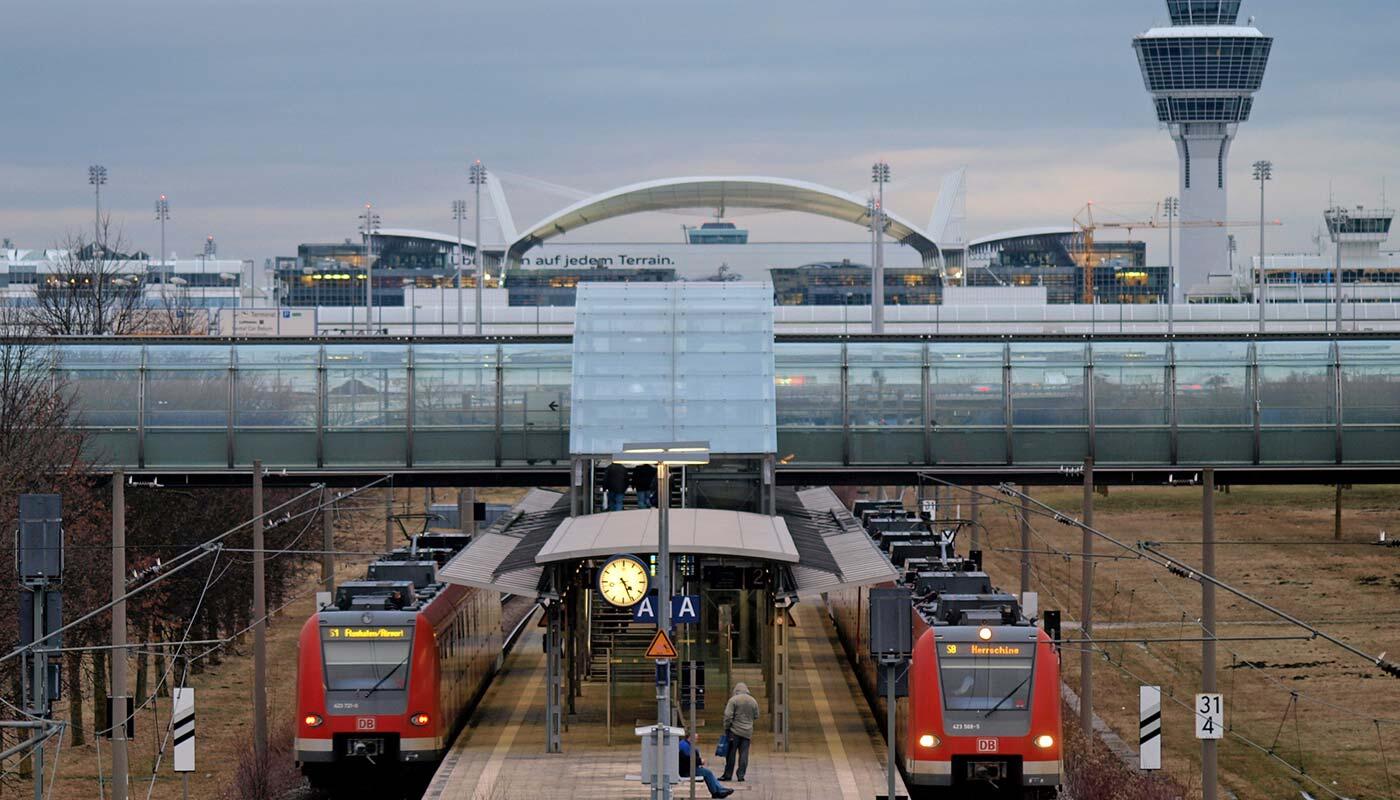 S-Bahn station Flughafen-Besucherpark Two trains stop at the S-Bahn station "Besucherpark". In the background you can see the tower of the Munich Airport.