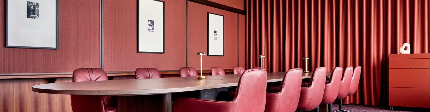municon Havanna Lounge Elegant meeting and lounge area in warm red tones with high-quality furnishings and a calm, focused atmosphere – ideal for meetings and confidential conversations.